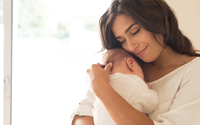 Mother and baby receiving Ayurvedic massage at 22 Ayur